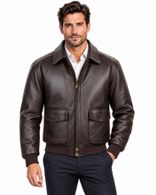 Charger l'image dans la galerie, A man wearing a dark brown leather aviator-style jacket over a white collared shirt and navy pants, photographed against a plain white studio background.