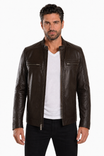 Load image into Gallery viewer, A man wearing a dark brown leather jacket over a white t-shirt and black pants, standing against a plain white background.