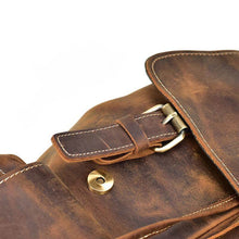 Load image into Gallery viewer, Close-up of The Hagen Backpack | Vintage Leather Backpack with brass buckle and natural creases in the cowhide leather