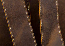 Load image into Gallery viewer, Close-up of The Langley Backpack straps showcasing genuine vintage leather texture and stitching.