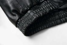 Load image into Gallery viewer, Close-up of REED Men's bomber jacket elastic hem in genuine leather