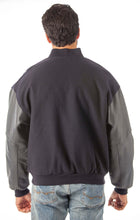 Load image into Gallery viewer, Model wearing REED Men's Premium Varsity Leather/Wool Jacket, USA-made, back view showcasing leather sleeves and classic design.