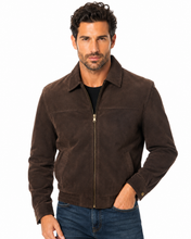 Charger l'image dans la galerie, A man wearing a dark brown suede zip-up jacket over a black shirt and blue jeans, photographed against a plain white background.