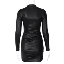Cargar imagen en el visor de la galería, Back view of black faux leather ruched mini dress with long sleeves and sleek design.
