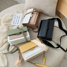 Load image into Gallery viewer, Assorted designer leather crossbody shopping bags in four colors: black, green, yellow, and brown, displayed on a chair.