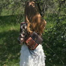 Cargar imagen en el visor de la galería, Woman wearing a stylish Bumblebee vegan leather backpack in a natural outdoor setting, perfect for professionals valuing style and function.