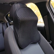 Load image into Gallery viewer, Black leather memory foam car pillow on a car seat, providing ergonomic neck support and luxurious comfort for enhanced driving experience.
