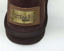 Cargar imagen en el visor de la galería, Close-up of REED Women's Suede Leather Boot with brand label, genuine leather and fur trim, showcasing 13-inch shaft detail.