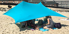 Load image into Gallery viewer, eZthings UV Light Sun Shade Protection Beach Shelter with sandbag anchors, offering sun protection, set up on a sandy beach.