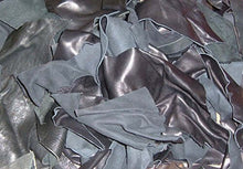 Cargar imagen en el visor de la galería, Pile of black leather scraps from garment cutting for crafts and arts projects, showcasing cowhide remnants from high-quality jackets.