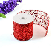 Load image into Gallery viewer, Red sparkly sheer fabric ribbon roll for gift wrapping and crafts, shown with purple flowers, ideal for decorative projects.