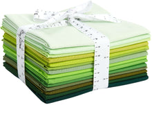 Load image into Gallery viewer, Stack of green fat quarter cotton fabrics in shades of emerald, perfect for quilting and crafts, tied with a measuring tape ribbon.