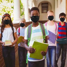 Load image into Gallery viewer, Kids wearing black face masks holding books in a school corridor.