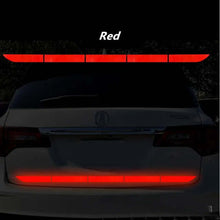 Load image into Gallery viewer, Car with red reflective warning tape on rear bumper enhancing visibility and safety
