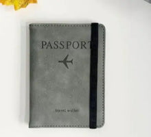 Load image into Gallery viewer, Alt Tag: Stylish leather passport holder with RFID-blocking feature for secure travel, featuring black strap and passport imprint.
