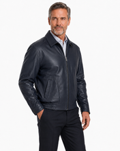 Charger l'image dans la galerie, A man wearing a  Reed leather jacket made in USA over a black button-down shirt, photographed against a plain white studio background.
