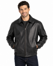Charger l'image dans la galerie, A man wearing a  Reed leather jacket made in USA over a black button-down shirt, photographed against a plain white studio background.
