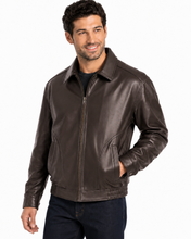Charger l'image dans la galerie, A man wearing a  Reed leather jacket made in USA over a black button-down shirt, photographed against a plain white studio background.
