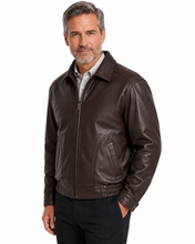 Charger l'image dans la galerie, A man wearing a  Reed leather jacket made in USA over a black button-down shirt, photographed against a plain white studio background.

