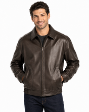 Charger l'image dans la galerie, A man wearing a  Reed leather jacket made in USA over a black button-down shirt, photographed against a plain white studio background.
