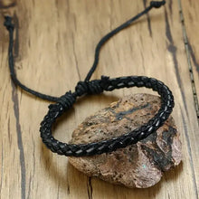 Load image into Gallery viewer, Elegant braided black leather wrap bracelet on a wooden surface, showcasing intricate design and craftsmanship for a sophisticated look.
