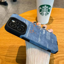 Load image into Gallery viewer, Luxury Leather Sneaker Phone Case on table next to Starbucks cup, showcasing sleek design and soft suede leather label.
