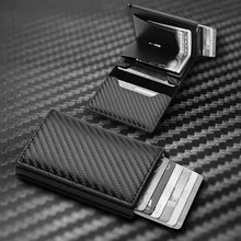 Load image into Gallery viewer, RFID Black Magic Trifold Vegan Leather Wallet showcasing open view with card slots on a carbon fiber surface.
