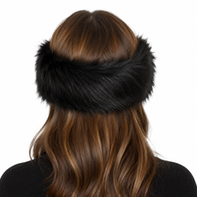 Charger l'image dans la galerie, A black faux fur headband worn by a model, viewed from the back. The model has long brown hair and is wearing a black ribbed top against a solid white background.
