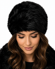 Charger l'image dans la galerie, A close-up of a woman wearing a black faux fur ushanka hat and a matching black faux fur coat against a plain white background.
