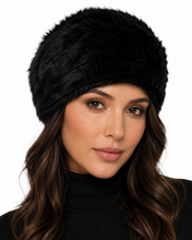 Charger l'image dans la galerie, A close-up of a woman wearing a fluffy black faux fur hat, shown from the chest up against a plain white background.
