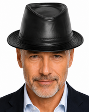 Load image into Gallery viewer, A close-up portrait of a man wearing a black leather fedora hat, a light blue dress shirt, and a dark suit jacket against a plain white background.
