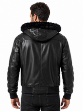 Load image into Gallery viewer, A man viewed from the back wearing a black faux-leather hooded jacket with a black faux-fur collar, paired with black jeans, against a plain white background.
