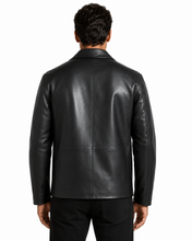 Cargar imagen en el visor de la galería, A man viewed from the back wearing a black leather jacket and black trousers against a plain white background.
