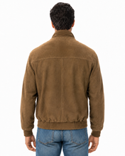 Load image into Gallery viewer, A man viewed from the back wearing a brown suede jacket and blue jeans against a plain white background.

