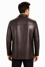 Charger l'image dans la galerie, A man viewed from the back wearing a dark brown leather jacket and black pants, photographed against a plain white studio background.
