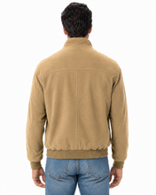 Load image into Gallery viewer, A man viewed from the back wearing a tan corduroy jacket and blue jeans against a plain white background.
