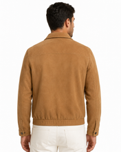 Charger l'image dans la galerie, A man viewed from the back wearing a tan suede jacket and white pants against a plain white background.
