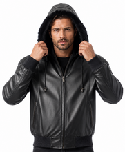 Load image into Gallery viewer, A man wearing a black faux-leather hooded jacket with a faux-fur trimmed hood, ribbed cuffs and hem, and a front zipper, shown against a plain white background.
