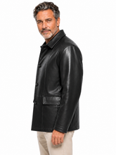 Cargar imagen en el visor de la galería, A man wearing a black leather jacket and beige pants, shown in a side profile against a plain white background.
