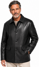 Cargar imagen en el visor de la galería, A man wearing a black leather jacket over a gray shirt and beige pants, photographed against a plain white studio background.
