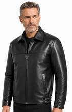 Load image into Gallery viewer, A man wearing a black leather jacket with a front zipper, stand-up collar, and zippered side pockets, photographed against a plain white studio background.
