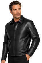 Load image into Gallery viewer, A man wearing a black leather jacket with a front zipper, stand-up collar, and zippered side pockets, photographed against a plain white studio background.
