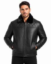 Charger l'image dans la galerie, A man wearing a black leather jacket with a quilted chest panel, a black collar, and a front zipper, photographed against a plain white background.
