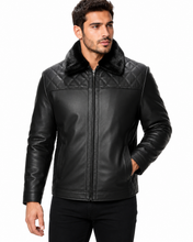 Charger l'image dans la galerie, A man wearing a black leather jacket with a quilted yoke, a plush black faux-fur collar, and a front zipper, photographed against a plain white background.
