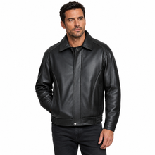 Load image into Gallery viewer, A man wearing a black leather jacket with a snap-button front and collar, paired with dark jeans, photographed against a plain white background.
