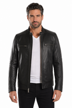 Load image into Gallery viewer, A man wearing a black leather motorcycle jacket over a white t-shirt and black pants, photographed against a solid white background.
