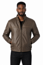 Cargar imagen en el visor de la galería, A man wearing a brown leather jacket with a front zipper, zippered chest pocket, and side pockets, paired with a black shirt and black jeans, against a plain white background.
