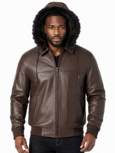 Load image into Gallery viewer, A man wearing a brown real -leather hooded jacket with a black fur trimmed hood, shown against a plain white background.
