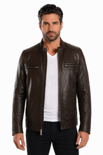 Load image into Gallery viewer, A man wearing a dark brown faux-leather biker jacket over a white t-shirt and black pants, standing against a plain white background.
