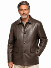 Cargar imagen en el visor de la galería, A man wearing a dark brown leather jacket over a beige shirt and light pants, photographed against a plain white background.
